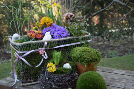 Jarní košík vyroben z rabicového pletiva a doplněn o květinové sezonní aranžmá