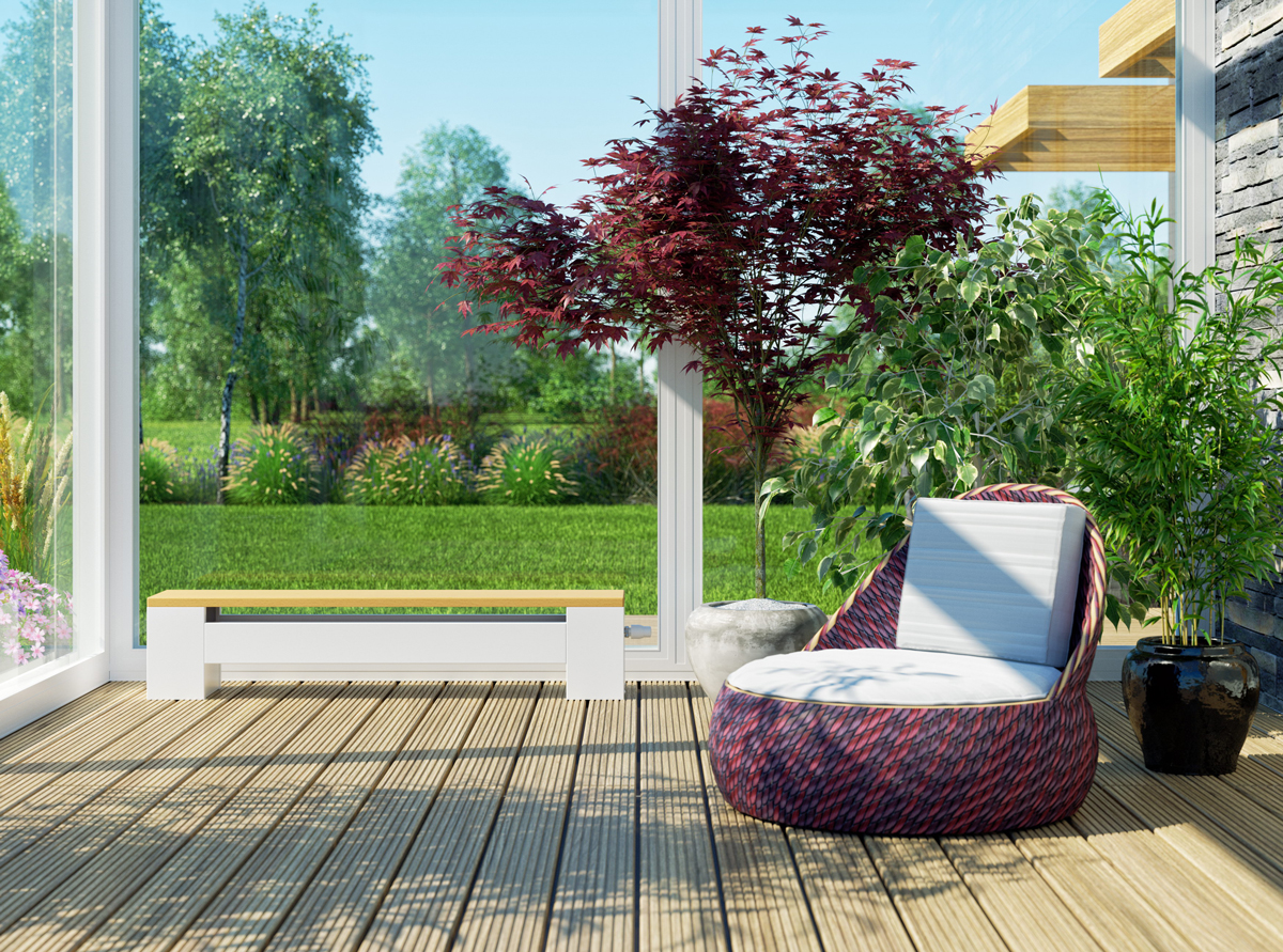 KORALINE LDX 30 26 140 buk vyssi format Designový konvektor KORALINE LD s dřevěnou lavicí v zimní zahradě – moderní topný radiátor pro energeticky úsporné vytápění interiéru s výhledem do zahrady.